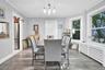 Dining room featuring radiator, crown molding, light wood finished floors, and a chandelier