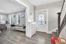 Foyer featuring light wood-style flooring, ornamental molding, plenty of natural light, recessed lighting, and stairway