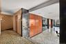 Hallway with tile walls and granite tiled floors