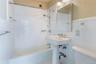 Full bathroom with bathtub / shower combination and tile walls