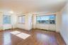 Unfurnished room with radiator heating unit, hardwood / wood-style floors, and crown molding