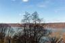 Water view with a heavily wooded area