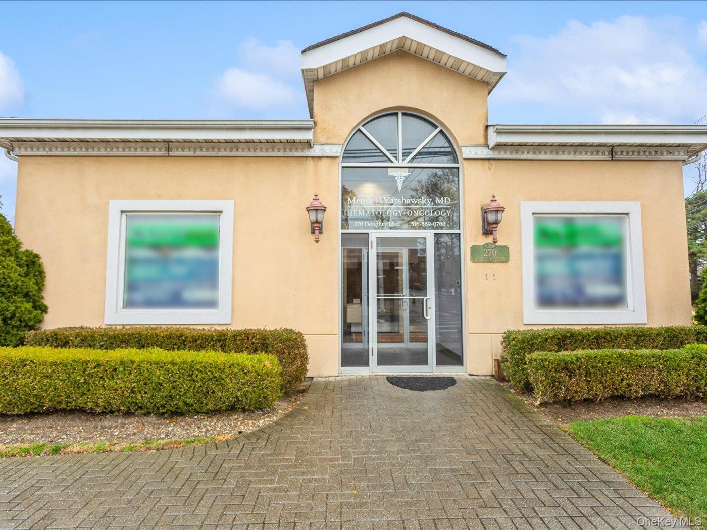 View of exterior entry with stucco siding