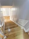 Staircase featuring wood finished floors