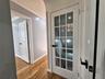 Hall with crown molding and wood finished floors