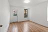 Unfurnished room featuring baseboard heating and light wood finished floors