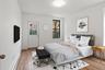 Bedroom featuring baseboard heating and light wood-type flooring