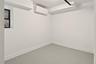 Empty room featuring a wall mounted AC and baseboards