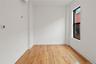 Spare room featuring light wood-style flooring and a wall mounted air conditioner