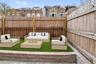 Fenced backyard with outdoor lounge area and a patio
