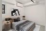 Bedroom featuring a wall mounted AC and baseboards