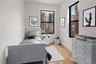 Bedroom featuring light wood finished floors and baseboards