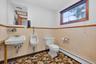 Bathroom with baseboard heating and toilet