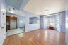 Unfurnished living room with light wood-style flooring and radiator