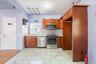 Kitchen with brown cabinets, appliances with stainless steel finishes, decorative backsplash, light countertops, and light marble finish flooring