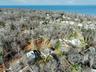Aerial overview of property's location with property parcel outlined and a large body of water