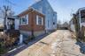 View of side of home with brick siding and driveway