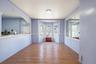 Empty room featuring wood finished floors, radiator heating unit, and healthy amount of natural light
