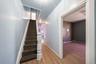 Stairs with baseboards and wood finished floors