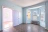 Empty room featuring radiator heating unit, healthy amount of natural light, parquet floors, and arched walkways