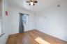 Empty room with hardwood / wood-style floors and a ceiling fan