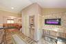 Living room with a wainscoted wall and ornamental molding