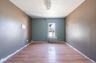Unfurnished room with light wood-style floors and radiator heating unit