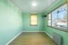 Empty room with radiator, light wood-style flooring, and crown molding