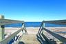 Surrounding community with view of water and beach