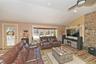 Living room with vaulted ceiling, wood finished floors, a ceiling fan, and recessed lighting