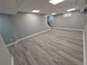Basement featuring stairway and light wood-style floors