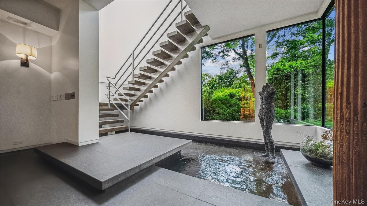 Entry Foyer is Graced By A Stainless Steel Floating Staircase