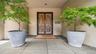 Entrance To The Interior Featuring Custom French Chateau Doors Set In Custom Bronze Metal Surround