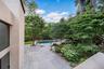 View of patio with an outdoor pool and view of scattered trees
