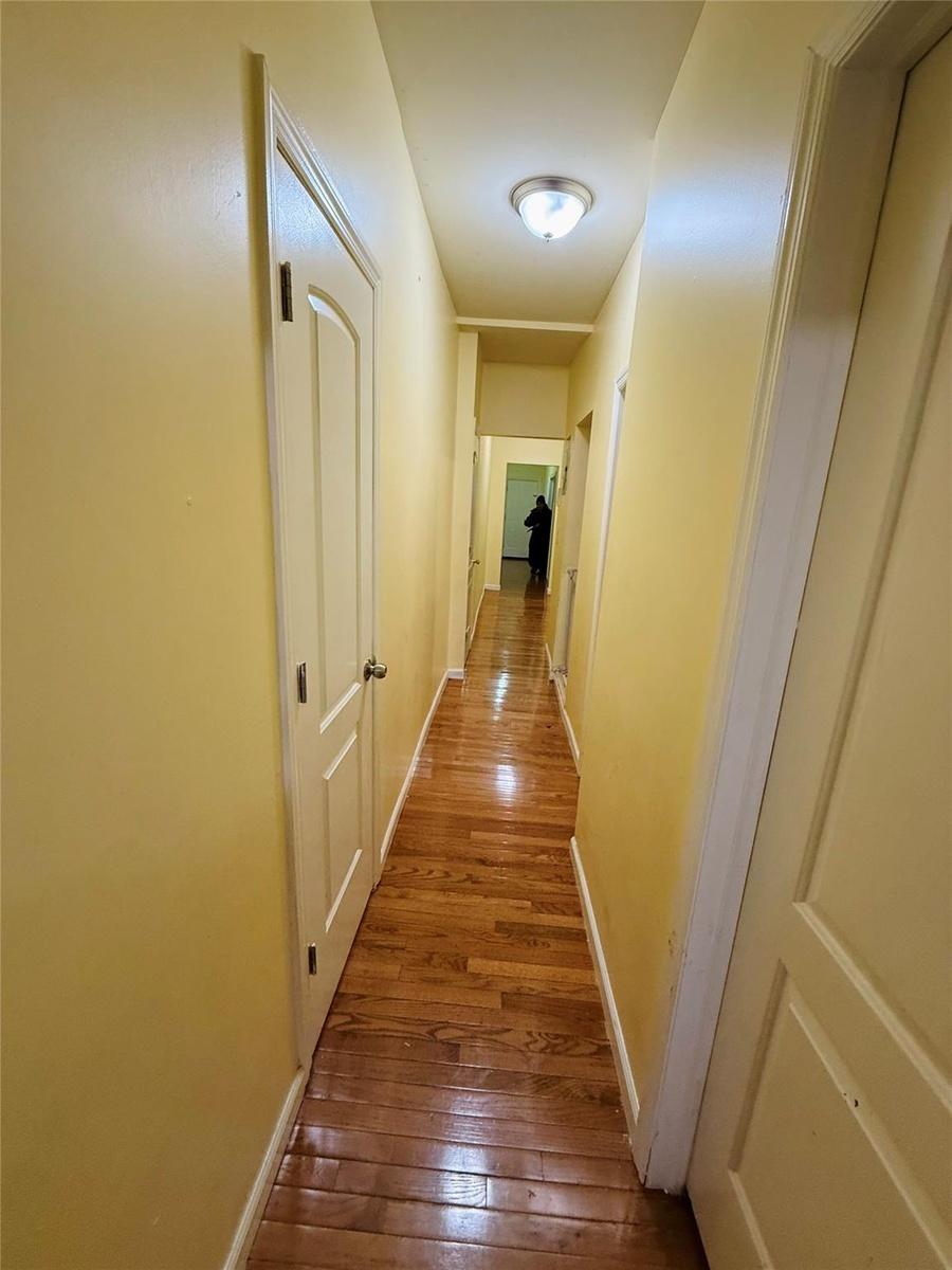 Hallway with hardwood / wood-style flooring