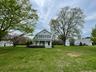 View of front of house featuring a front lawn and a porch