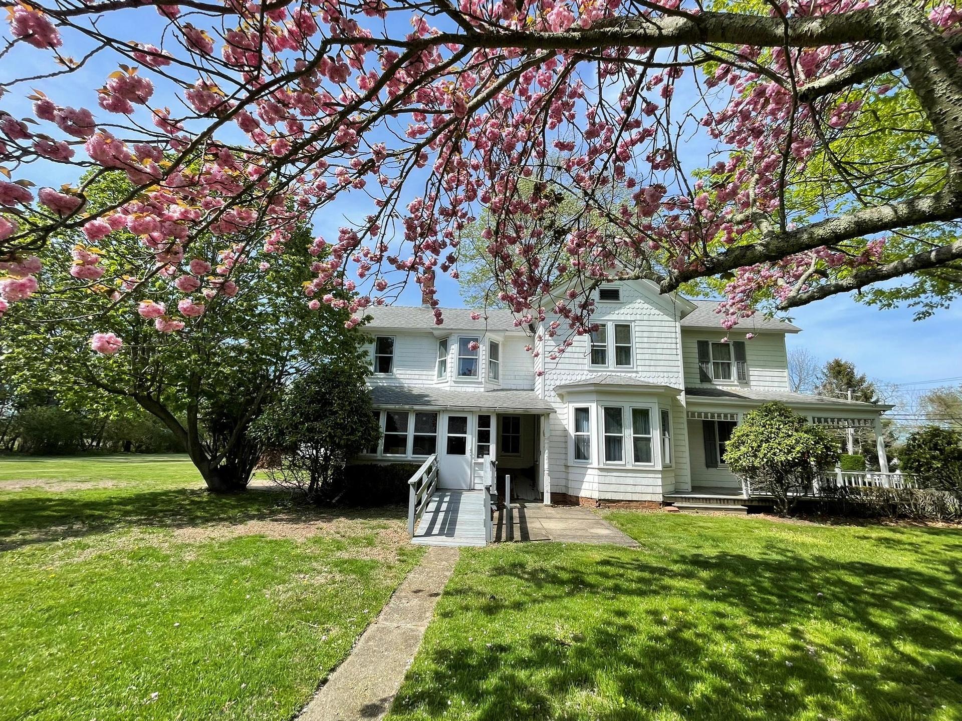 Rear view of house featuring a yard
