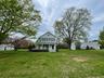 View of front of home with a front lawn and covered porch