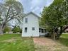 Back of property featuring a yard and a sunroom