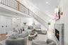 Living room featuring a fireplace, stairway, recessed lighting, wood finished floors, and a towering ceiling