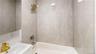 Bathroom with bathing tub / shower combination and vanity