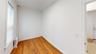 Empty room featuring light wood-type flooring and radiator