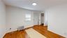 Unfurnished bedroom with radiator and light wood-type flooring