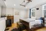 en suite bedroom with private bathroom, hardwood floors and lots of natural light