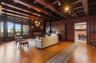 Parlor with fireplace, all original wood details and beamed ceiling