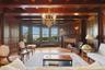Parlor featuring original oak floors,  a custom mermaid chandelier, and a brick fireplace