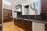 Kitchen featuring hi end stainless steel appliances hardwood floors and lots of cabinetry