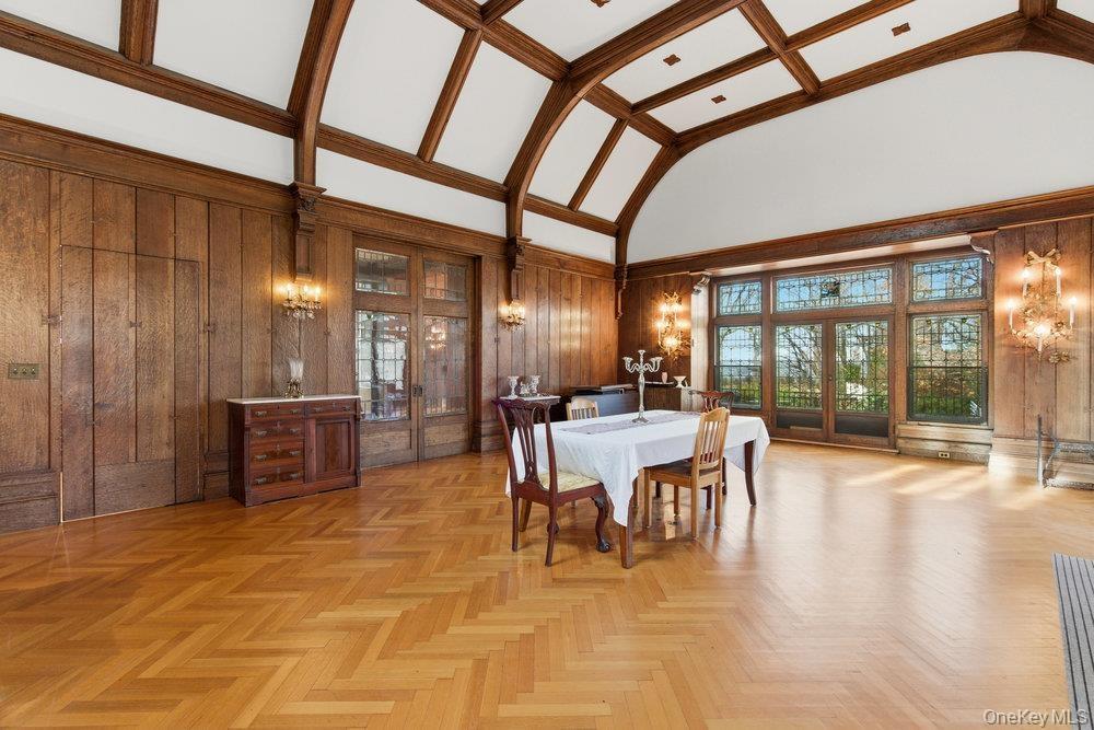 Banquet sized dining room with leaded glass french doors to patio,  pocket doors to original entry foyer and kitchen access