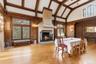 Banquet sized Dining room with high vaulted ceiling,   and a large fireplace, leaded glass windows with stained glass accents