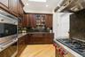 Kitchen featuring 6 burner propane wolf cooktop, wolf double wall oven and sub zero refrigerator